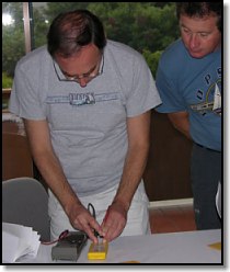 Chris Hoffman (McMurdo Director of Engineering) checks dead PLB battery during recoding session