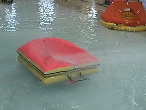 Canopy collapsed on Survival Products rafts during simulated storm.